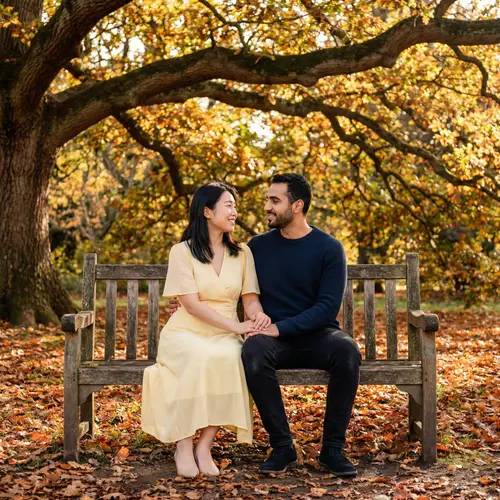Romantic Scene of East Asian Woman & Middle Eastern Man on Park Bench