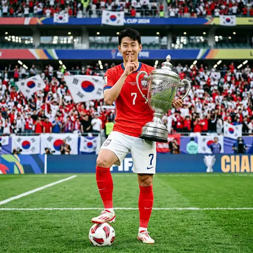 Asian Male Football Player with Trophy on Grass Field