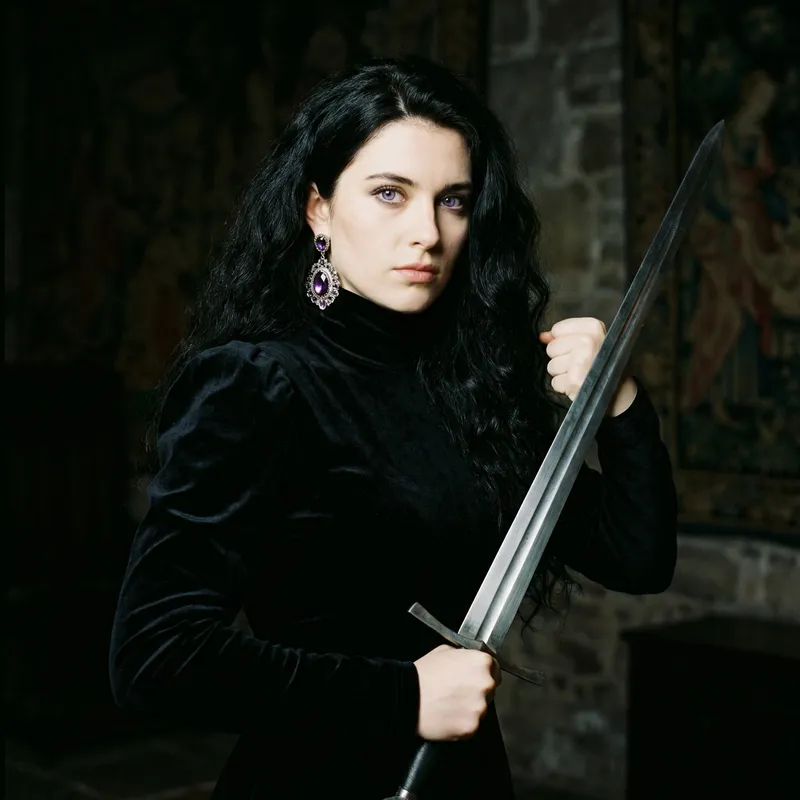 Young English Girl with Black, Thick, Long Wavy Hair and Violet Eyes Holding Sword
