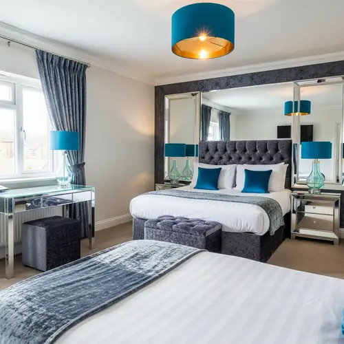 Elegantly Vibrant Double Bedroom with Mirrors and Velvet Accents