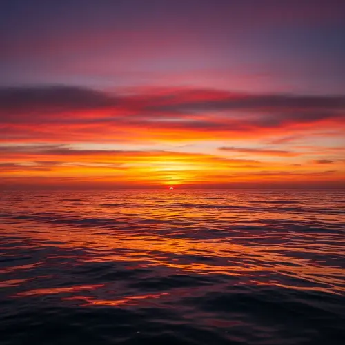 Mesmerizing Sunset at Sea: A Spectacle of Reds, Oranges, and Purples