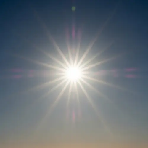 Vivid Sun at High Noon: Radiant Colors in Cloudless Sky