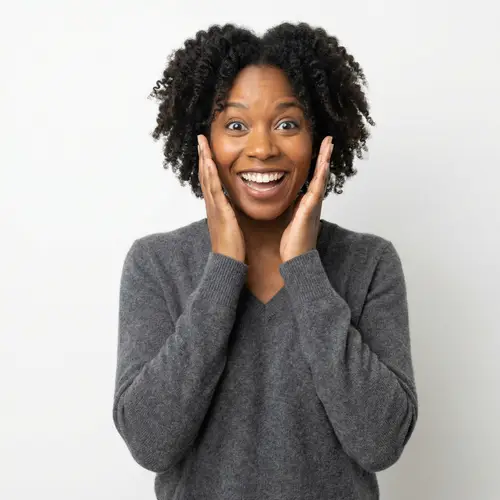 Surprised African American Woman in Cozy V-Neck Cashmere Sweater
