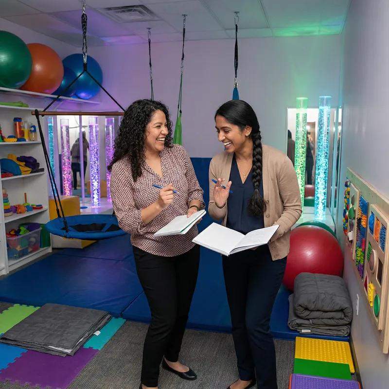 Occupational Therapists Discussing Differential Diagnosis in Sensory Stimulation Room