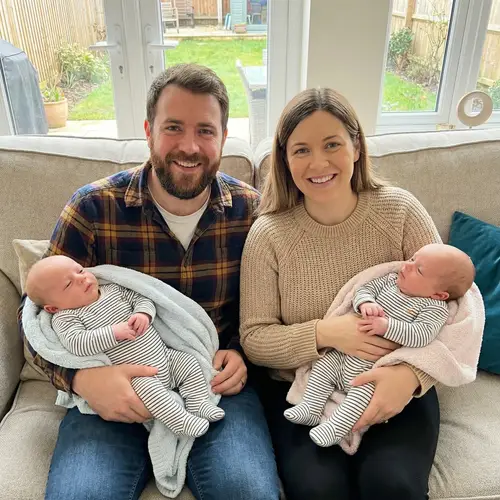 Joyful Parents with Their Twin Babies