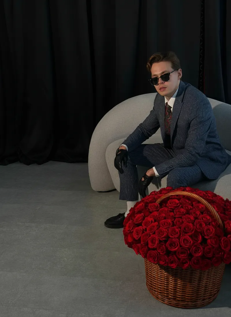 Elegant Young Man in Striped Suit with Red Roses
