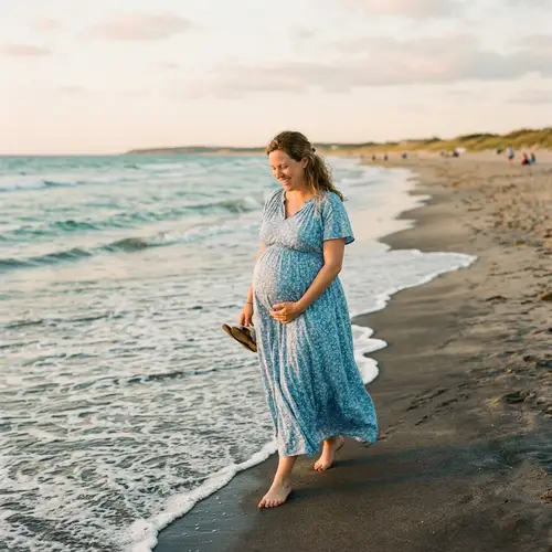 Happy Pregnant Mother Strolling on the Beach