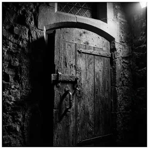 Weathered Wooden Door in Film Noir Style - Black & White Photo
