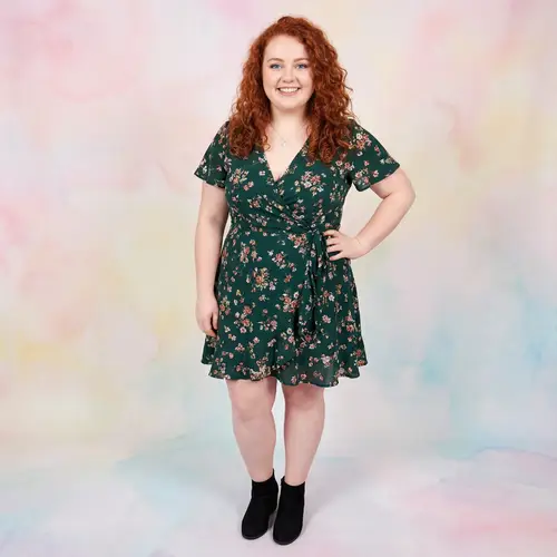 Confident Plus-Size Woman in Chic Green Dress