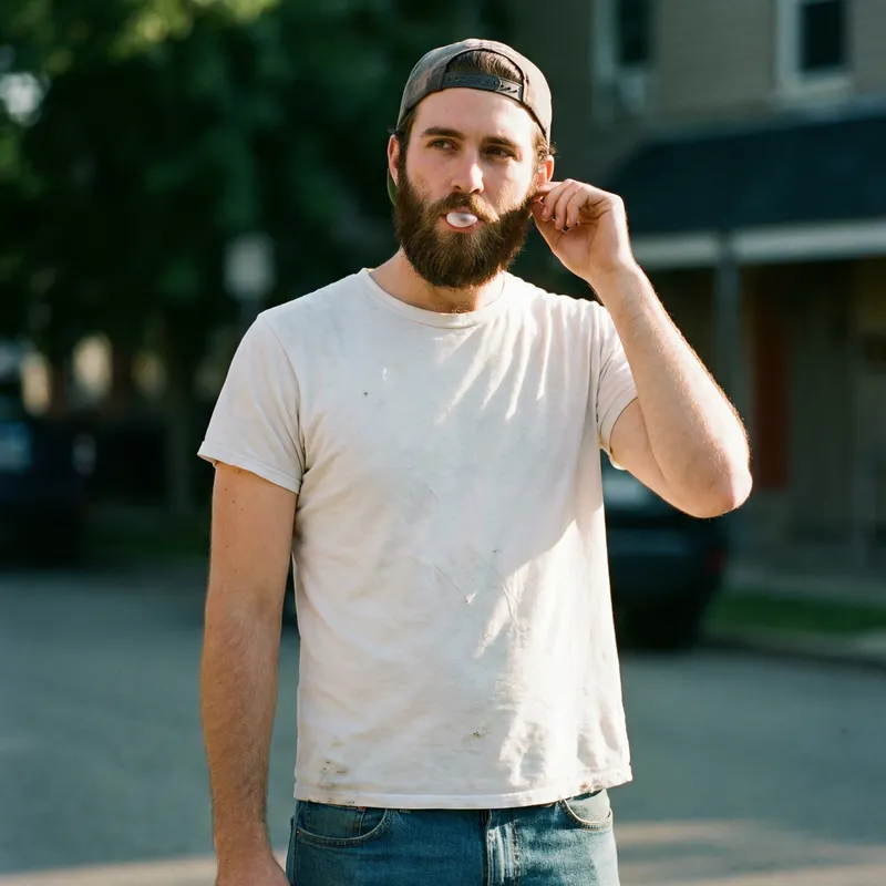 Stylish Young Man in White T-shirt and Blue Jeans | Beard & Cap
