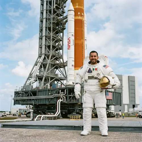 Hispanic Astronaut in Front of Rocket