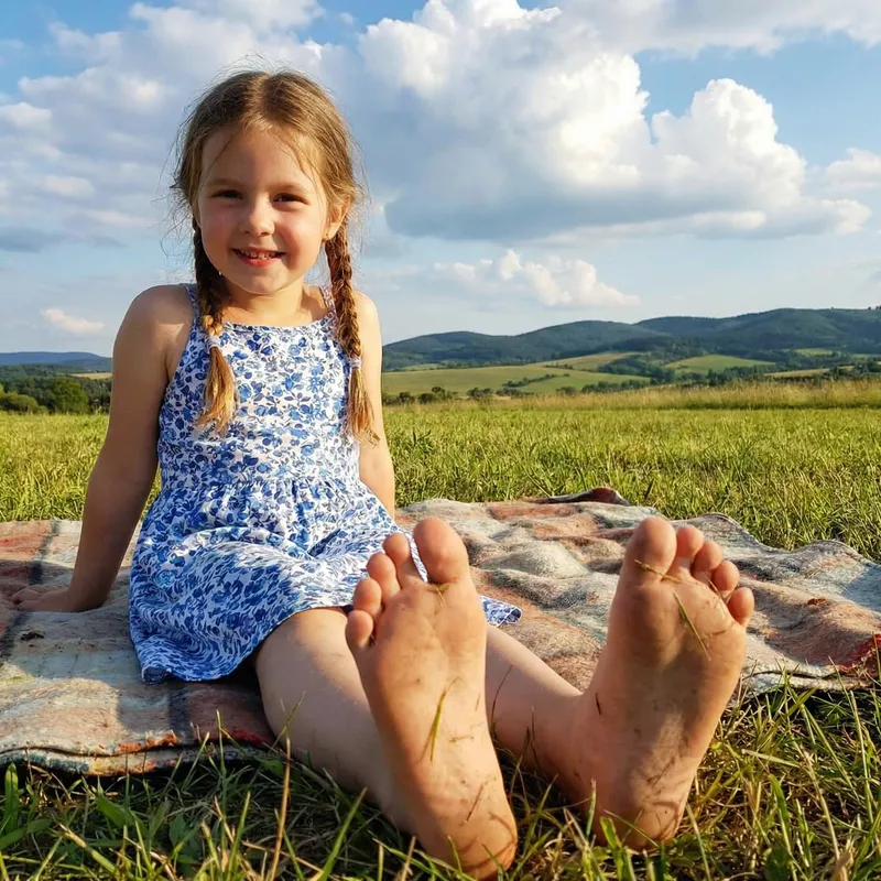 Joyful Moments: Young Girl in a Sunny Field