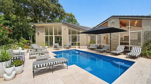 Cozy Pool Area with Striped Lounge Furniture