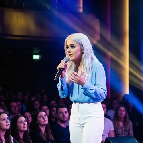 Passionate Young Woman Singing On Colorful Stage | Performance