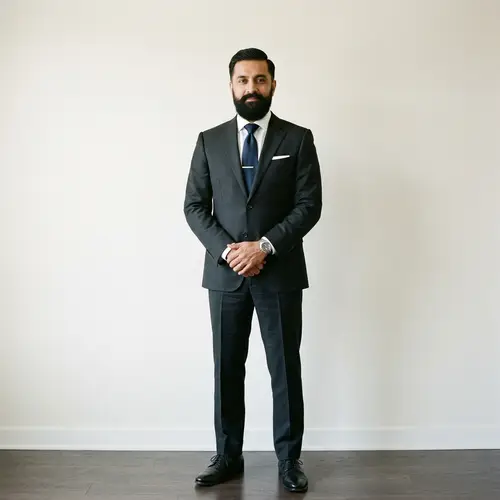 Confident Middle-Aged South Asian Man in Charcoal Suit