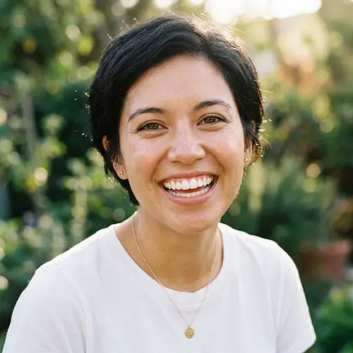 Close-Up Portrait of Person with Short Black Hair and Brown Eyes