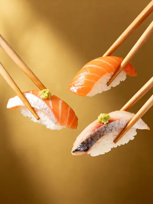 Realistic Sushi Held by 3 Chopsticks