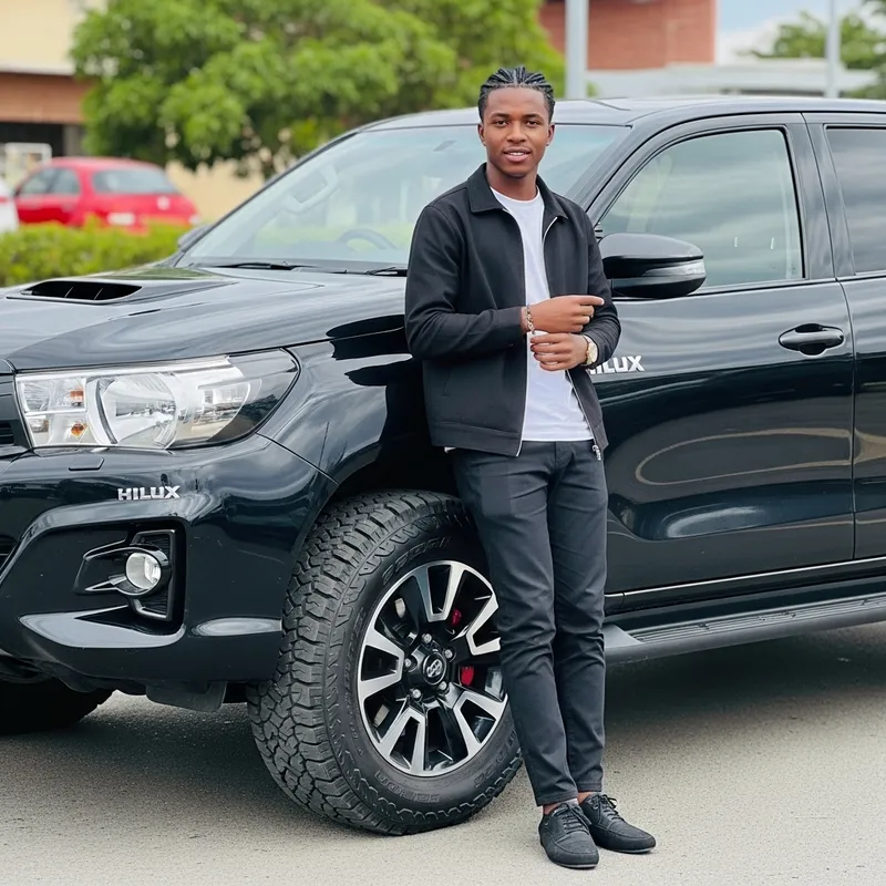 Handsome African Man with Black Hilux - Stylish Pose Handsome African Man with Black Hilux - Stylish Pose