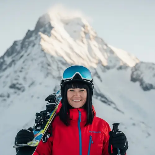 Smiling White Woman Skiing in Snowy Mountain Landscape
