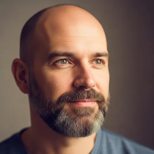 Stylish Bald Man with Beard in His Mid 30s