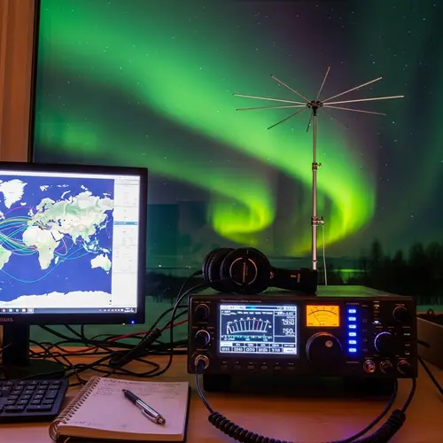 Ham Radio Transceiver Setup with Yagi Antenna under Aurora Borealis