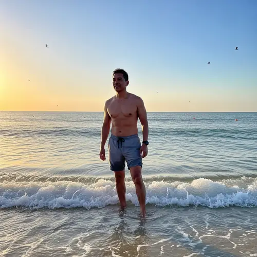 Middle-Aged South-Asian Man in Casual Shorts by Calming Sea