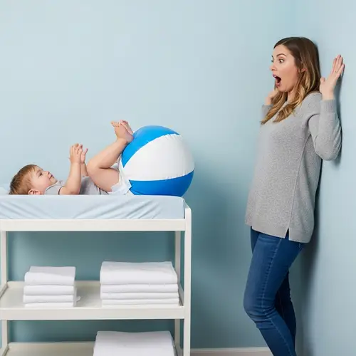 Adorable Toddler in Oversized Inflated Diaper on Changing Table