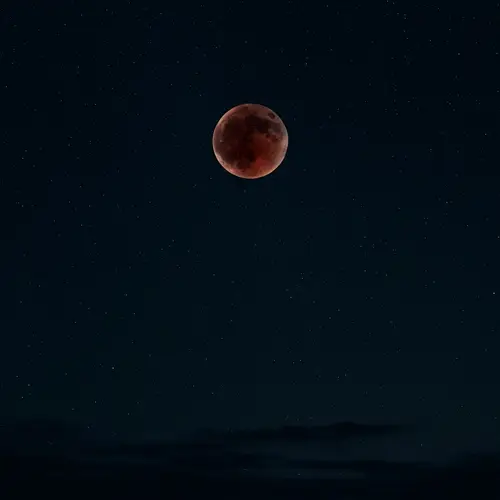 Captivating Blood Moon in Dark Starry Sky