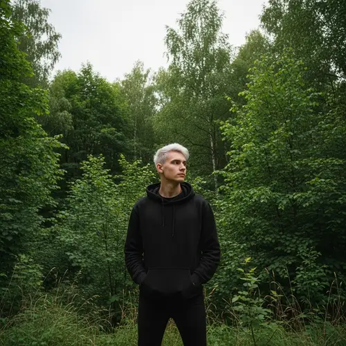 Slim Caucasian Man in Black Hoodie near Forest | Contemplative Pose