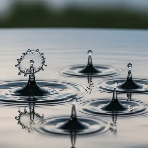 Water Droplets Creating Ripples with One Standing Out