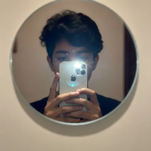 Anonymous South Asian Boy Taking Mirror Selfie with iPhone