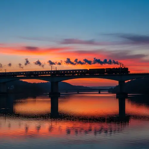 Stunning Sunset Bridge Scene with Passing Train | As Seen from a Vibrant Perspective