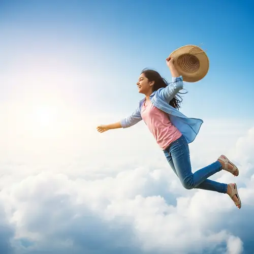 Joyful South Asian Girl Soaring in Blue Sky | Serene Sunlight Image