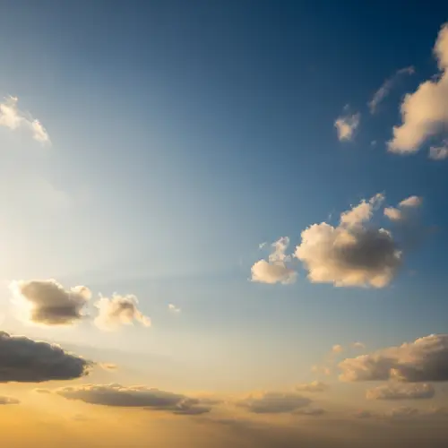 Tranquil Wide Expansive Sky: Vast Views of Golden Horizons & Fluffy Clouds