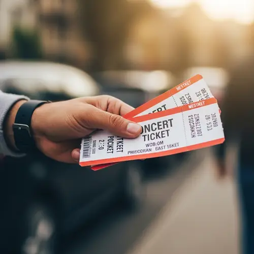 Close-Up Human Hand Grasping Concert Tickets with Care