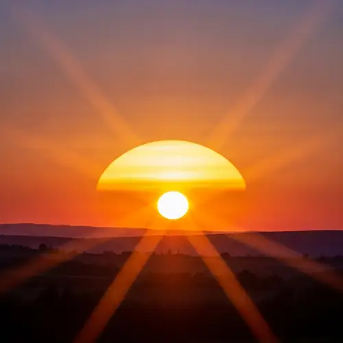 Golden Sun Setting: Radiant Landscape in Warm Colors