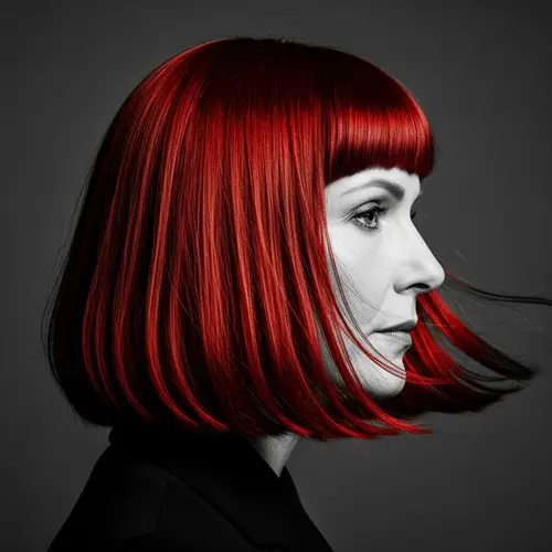 Dramatic Black & White Portrait of a Middle-Aged Woman with Vibrant Red Hair