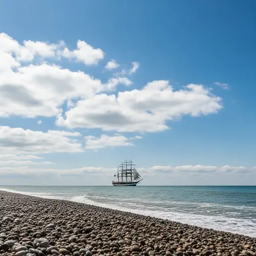 Tranquil Seascape with Grand Sailing Ship | Glistening Pebble Beach