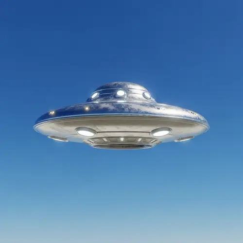 Silvery UFO Hovering in Brilliant Blue Sky