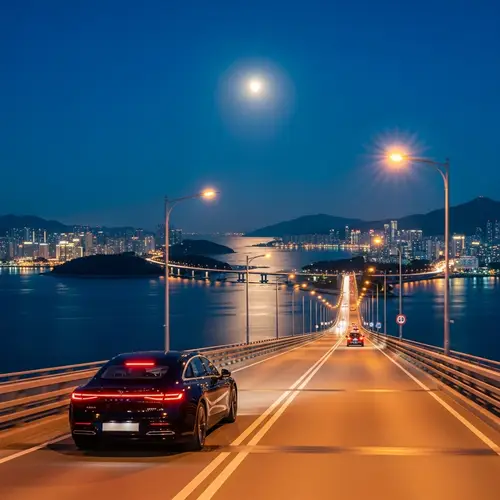 Luxury Electric Car Driving on Moonlit Bridge Over Sea Strait