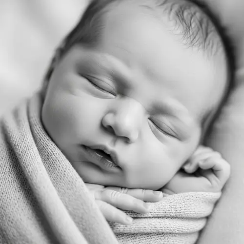 Peaceful Newborn Baby Sleeping in Black and White