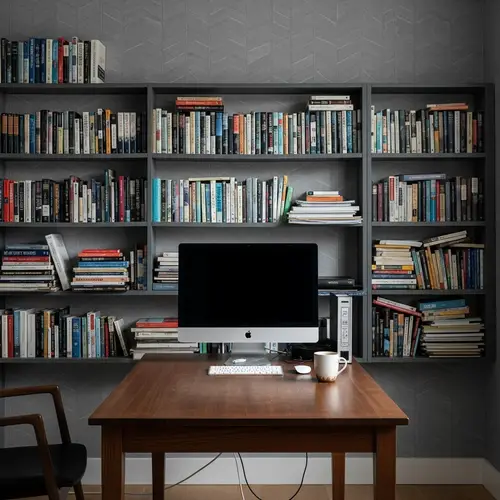 Dark Wood Table with Computer, Monitor, Books, and Tea Mug