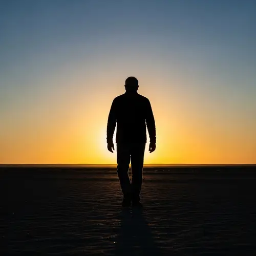 Silhouette Man Walking Away at Sunset