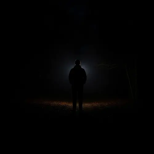 Solitary Figure in Dark Shadow: A Compelling Image of Solitude and Peace