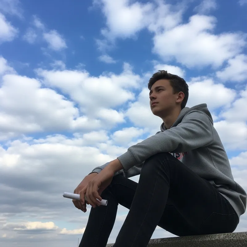 Contemplative Boy Gazing at the Sky | Peaceful Image