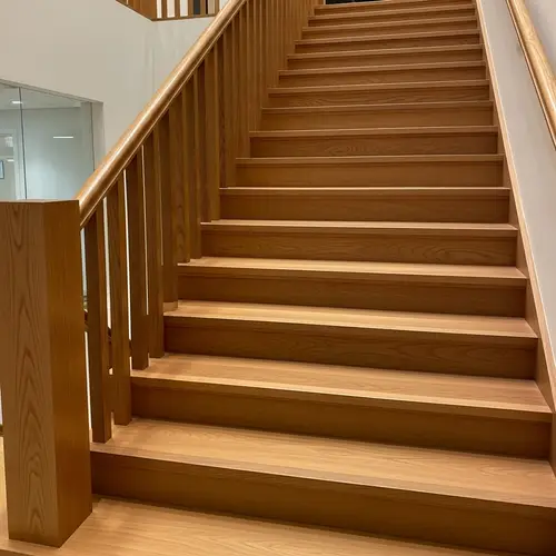 Polished Wooden Staircase with Warm Lighting