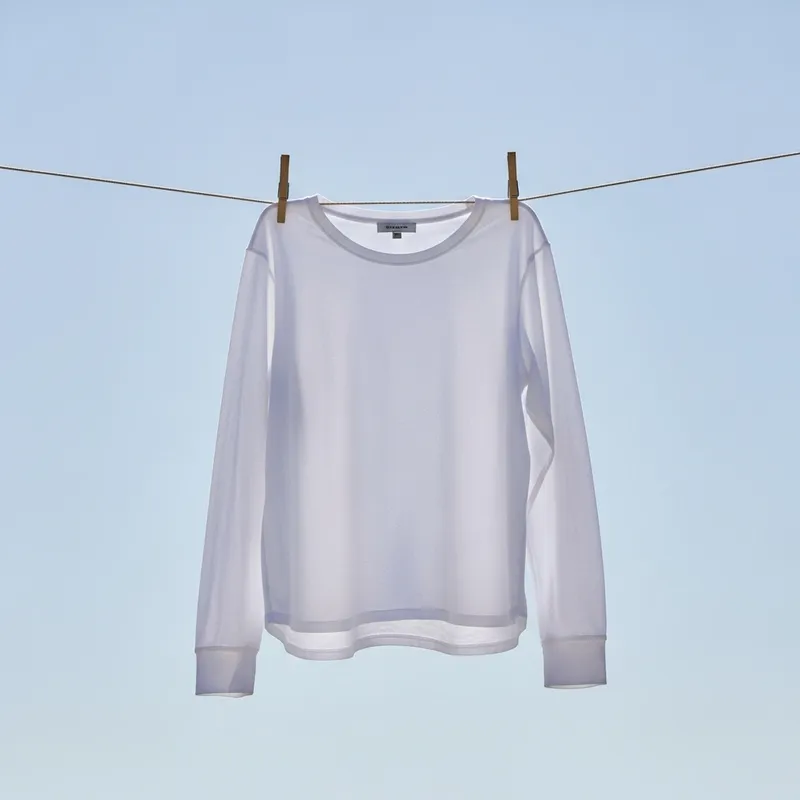 Solid White Long Sleeve Shirt | Close-Up on Blue Sky