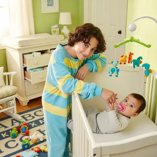 Curly Haired 14-Year-Old Stealing Pacifier from Baby Brother