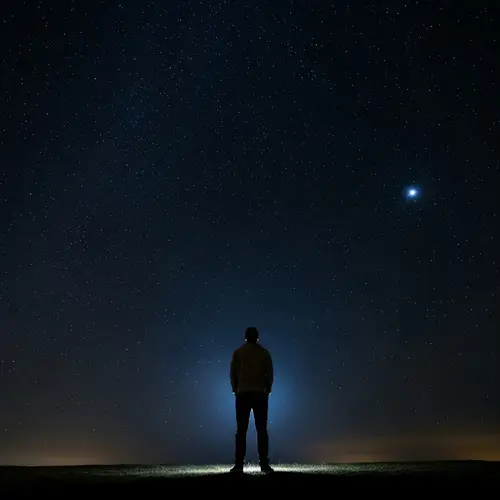 Hispanic Man Under Dark Starlit Sky