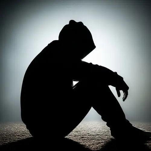 Silhouette of a Contemplative Figure in Hood - Mystery Captured